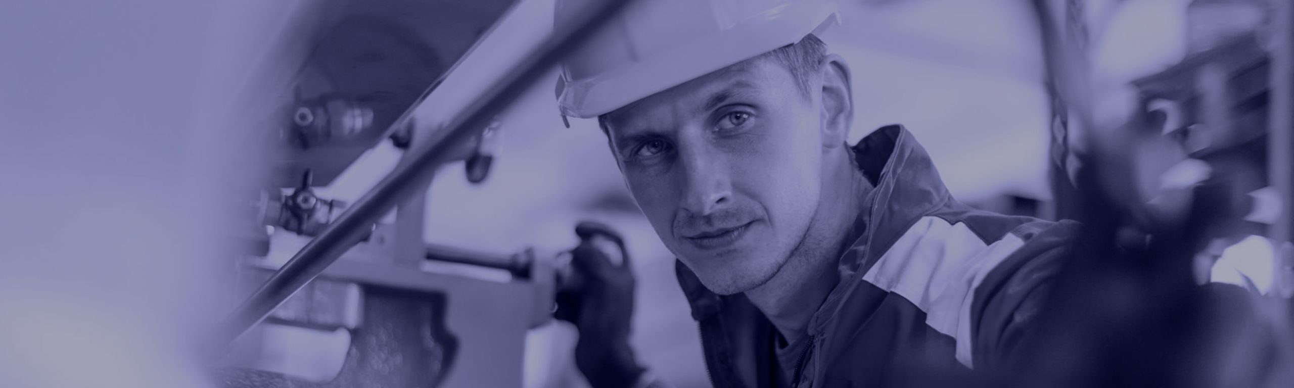 Man in hardhat adjusting machine